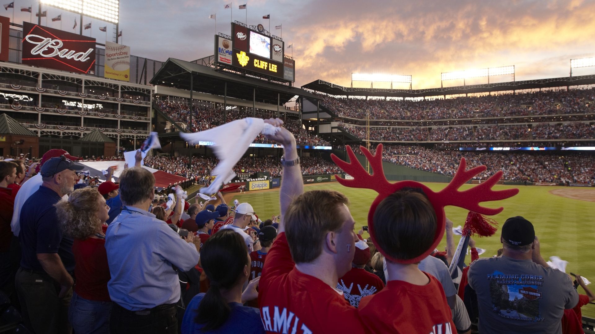 A baseball stadium with fans in the foreground.