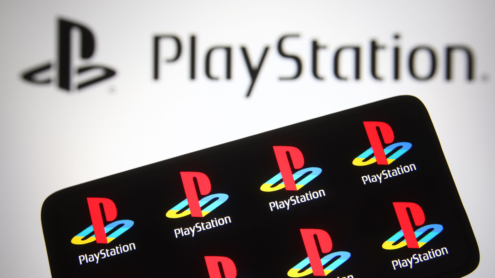 Photo of a screen displaying PlayStation logos