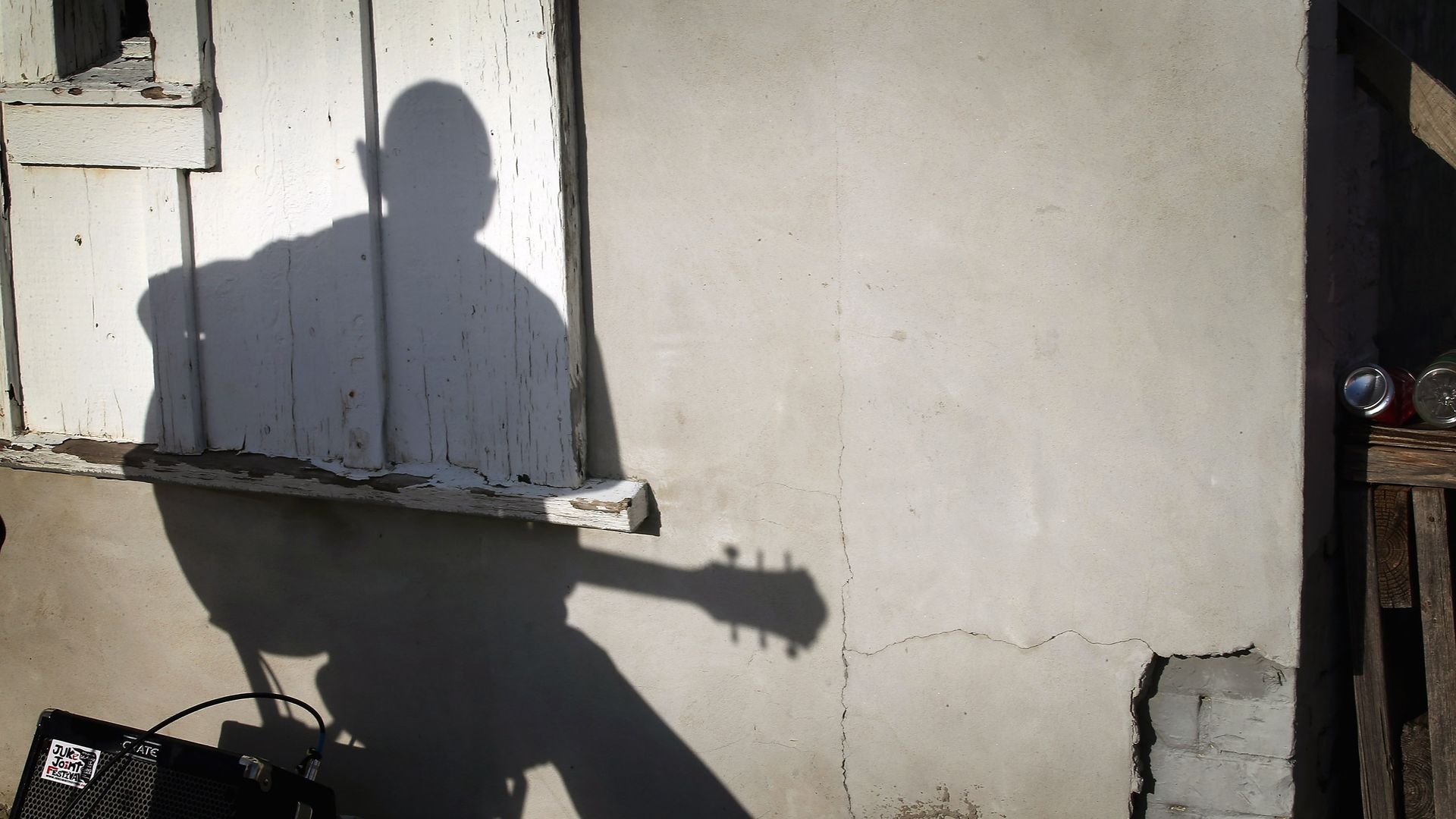 Blues artist Tada Ikemasu casts a shawdow as he plays outside the Club Vegas Blues Lounge, April 13, 2013, in Clarksdale, Mississippi.