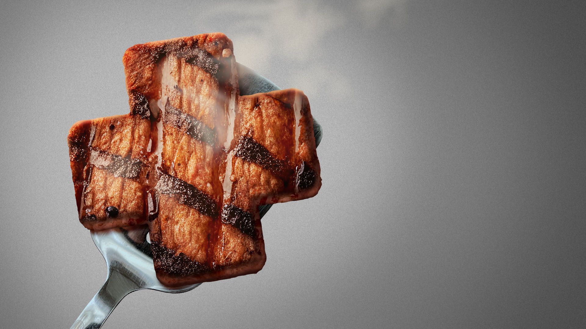 A cross-shaped piece of grilled meat, with visible char lines and steam rising from it, resting on a shiny spatula against a plain background.
