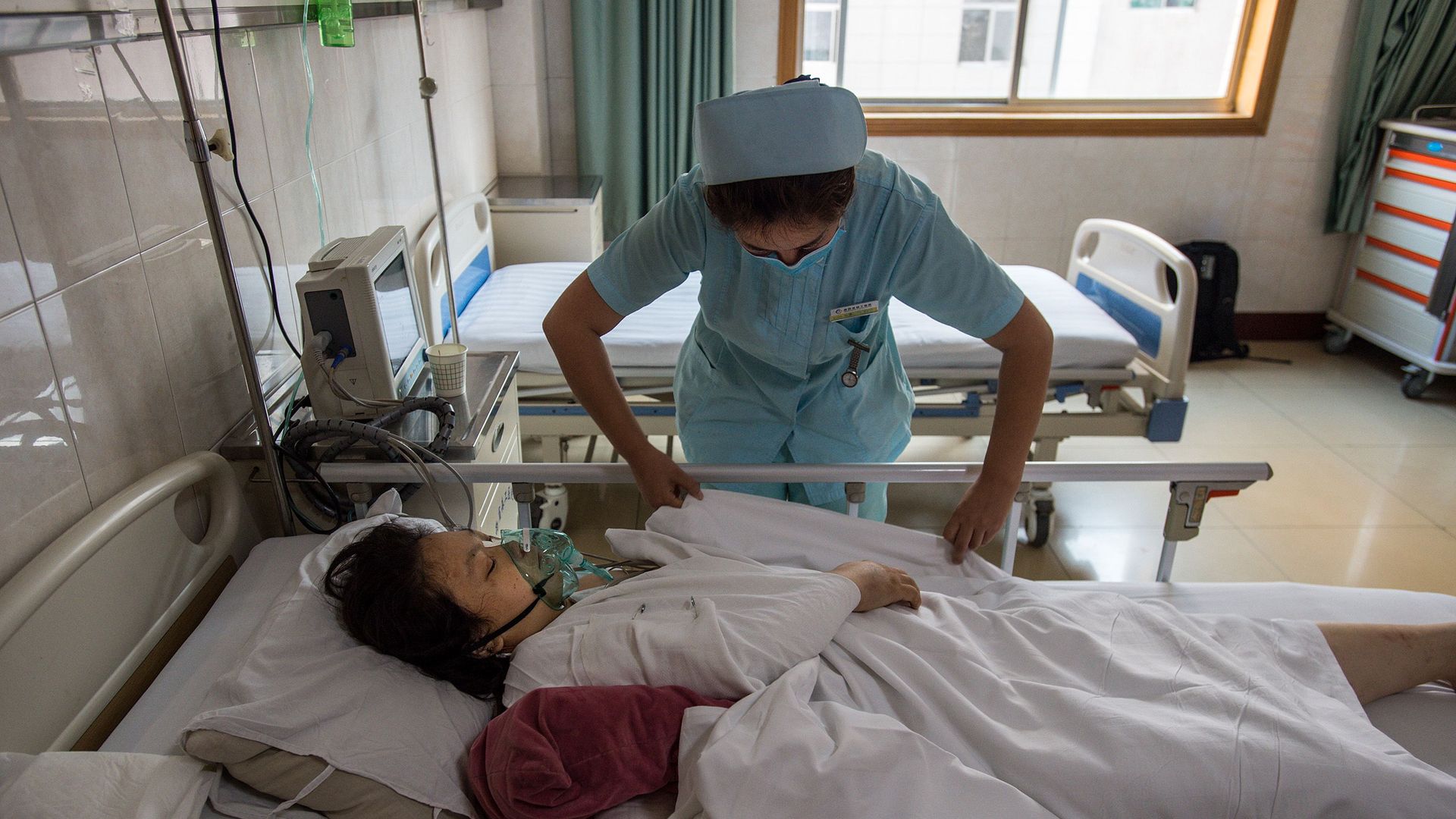A nurse treats a patient in a Chinese hospital.