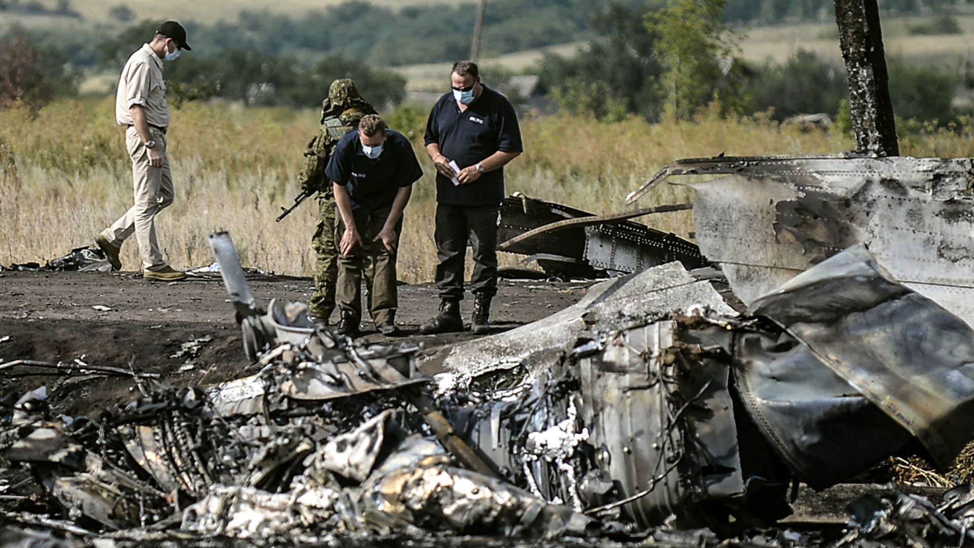 Investigators work at a the crash site of the Malaysia Airlines Flight MH17 in 2014.