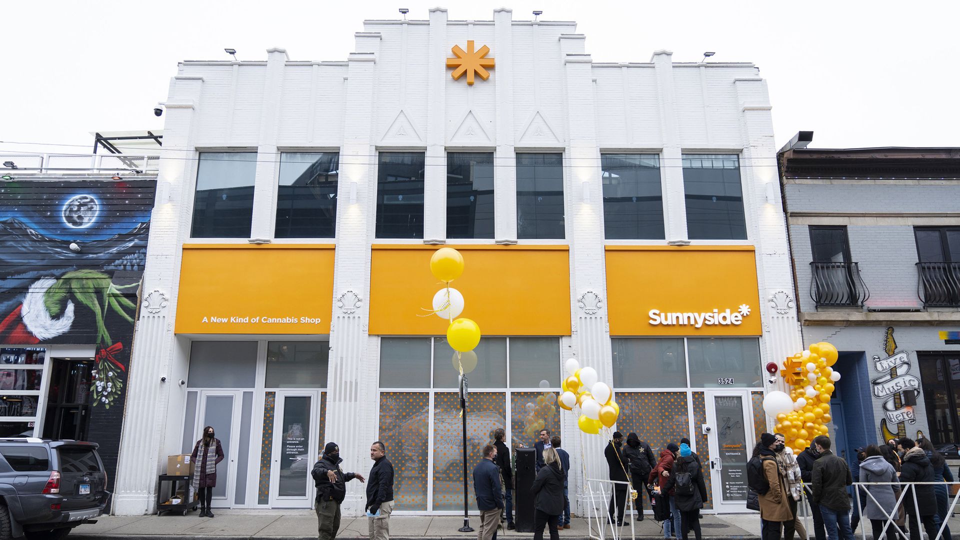 Photo of people mulling about in front of a buidling.