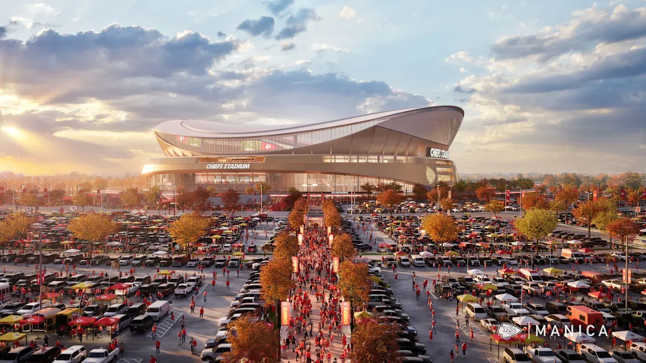 A futuristic stadium labeled "Chiefs Stadium" rises over a vast parking lot and a tree-lined central promenade filled with red-clad fans, tents, and vendors at sunset.