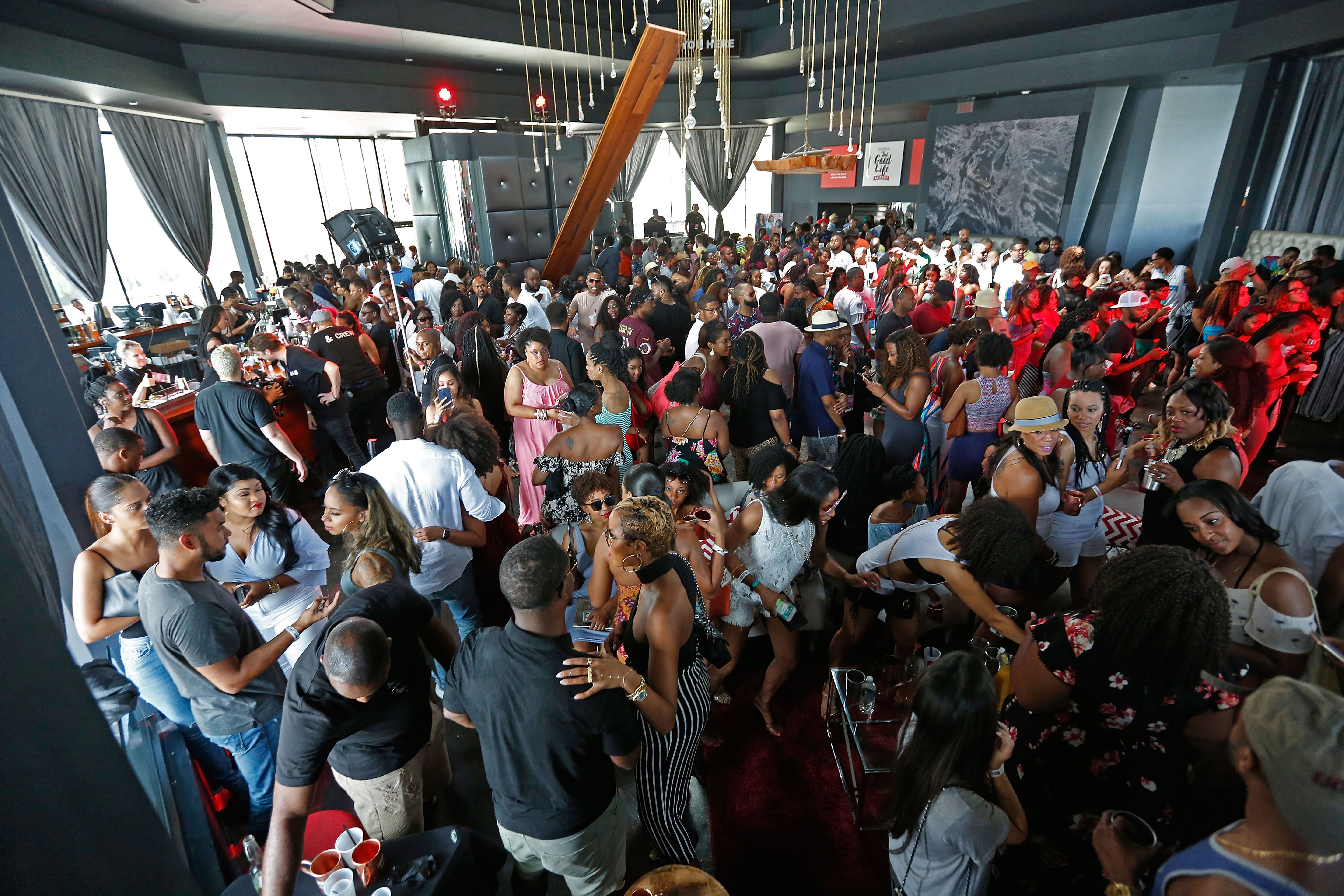 A very crowded room during a party.