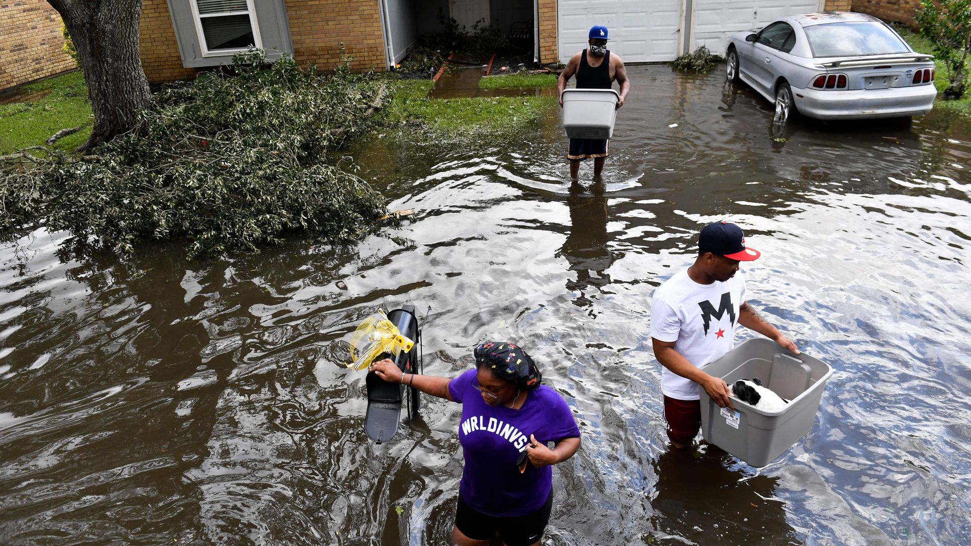 People evacuate their flooded home