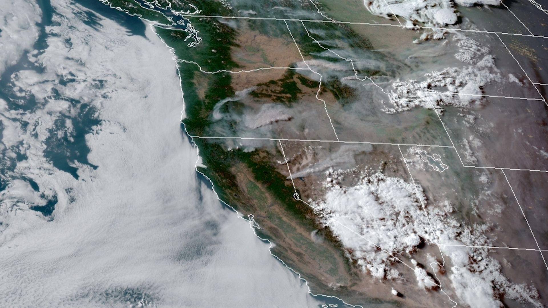 Satellite view of the West Coast with clouds and wildfire smoke seen.