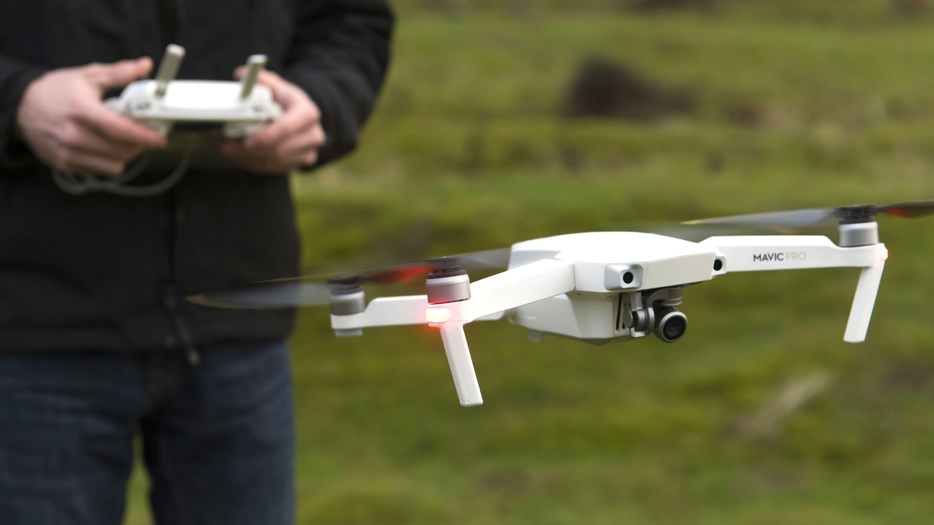 Photo of a small drone flying near its operator