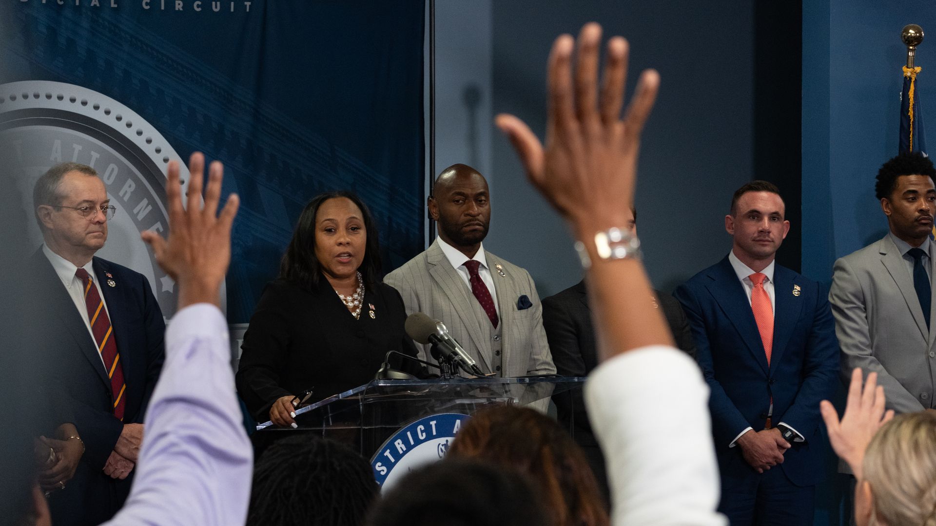 Fani Willis stands with her legal team, including special prosecutor Nathan Wade, during a press conference