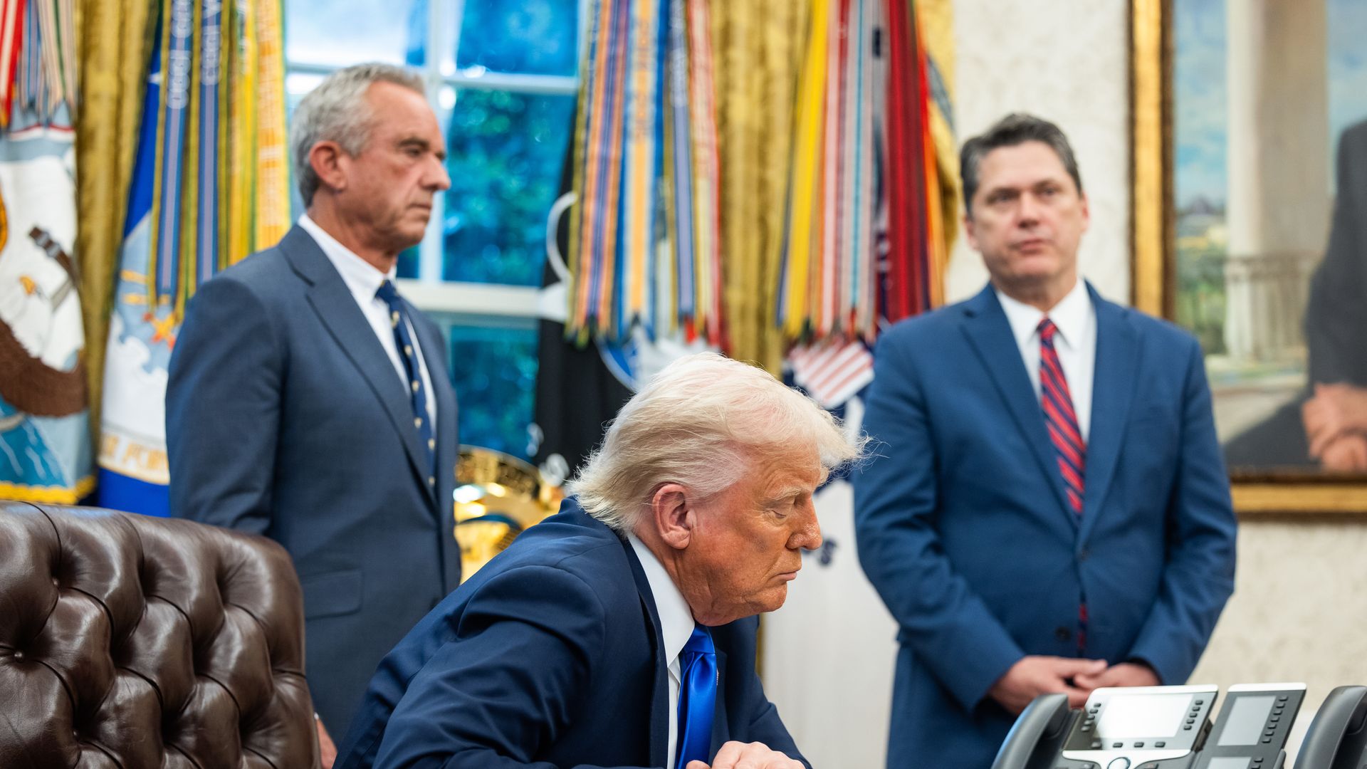 US President Donald Trump, center, during an executive order signing in the Oval Office of the White House on Monday, May 5, 2025.