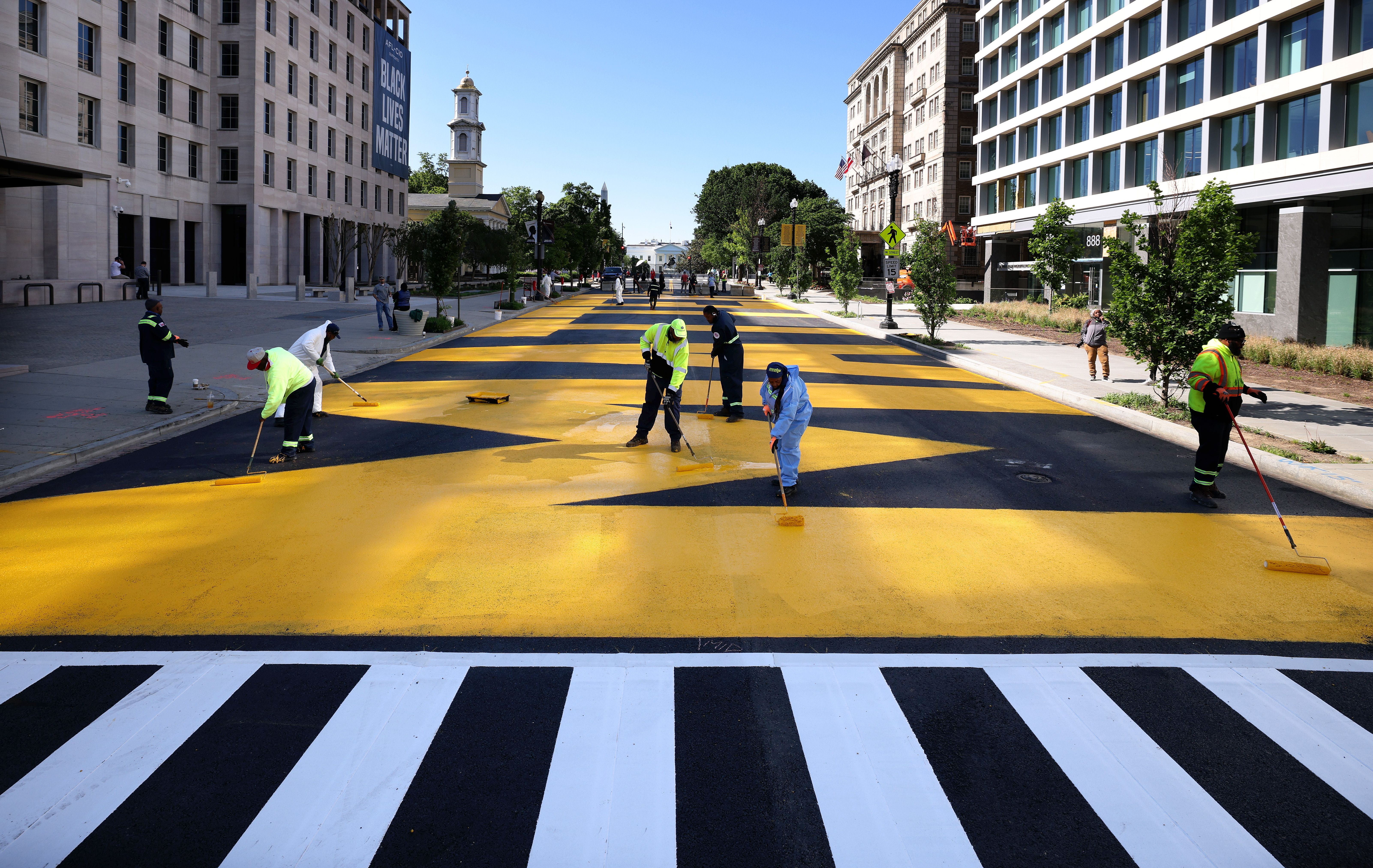 City crews paint Black Lives Matter Plaza