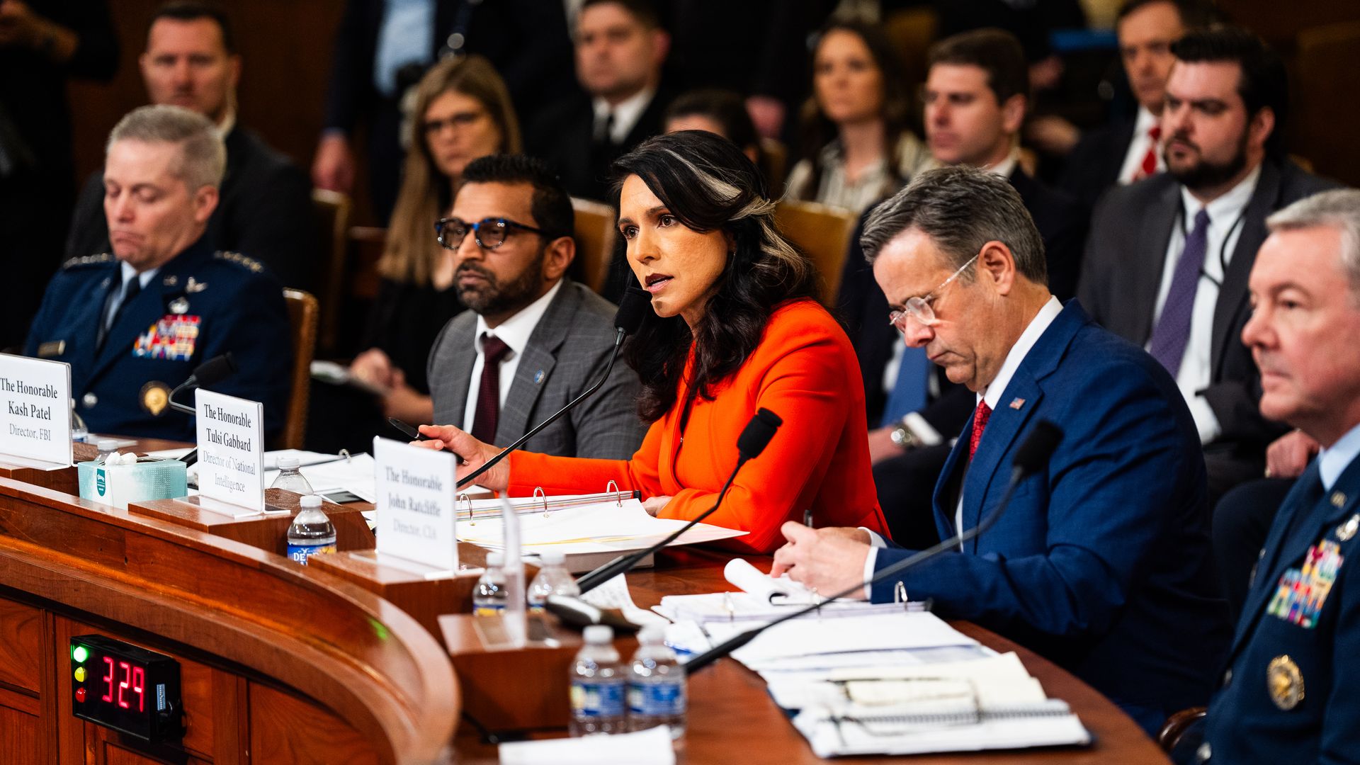  Tulsi Gabbard, flanked by Kash Patel and John Ratcliffe, speaks during an Intelligence Committee hearing on Capitol Hill.