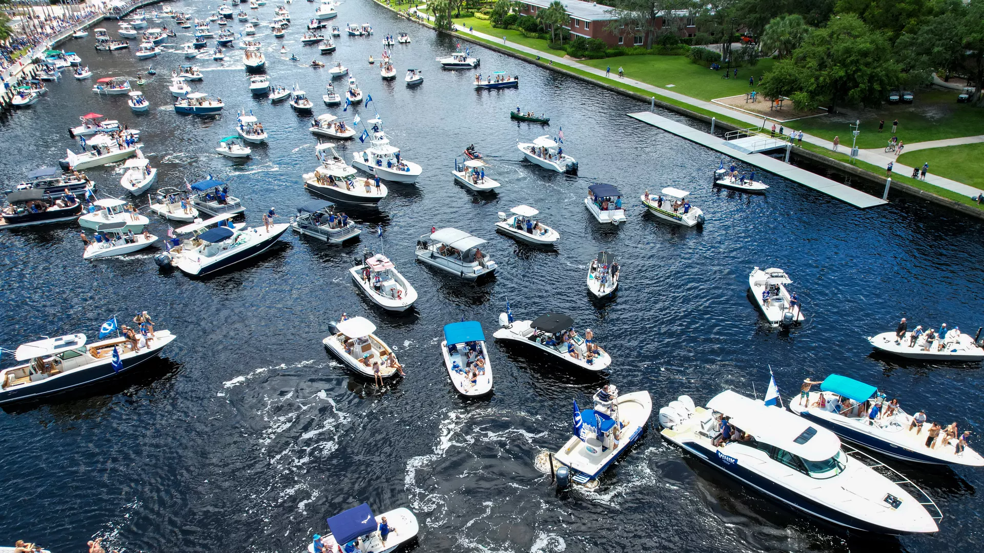 A ton of boats float on a river