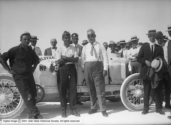 Photo of men standing around a car in 1914. The car is the Blitzen Benz, an early race car.