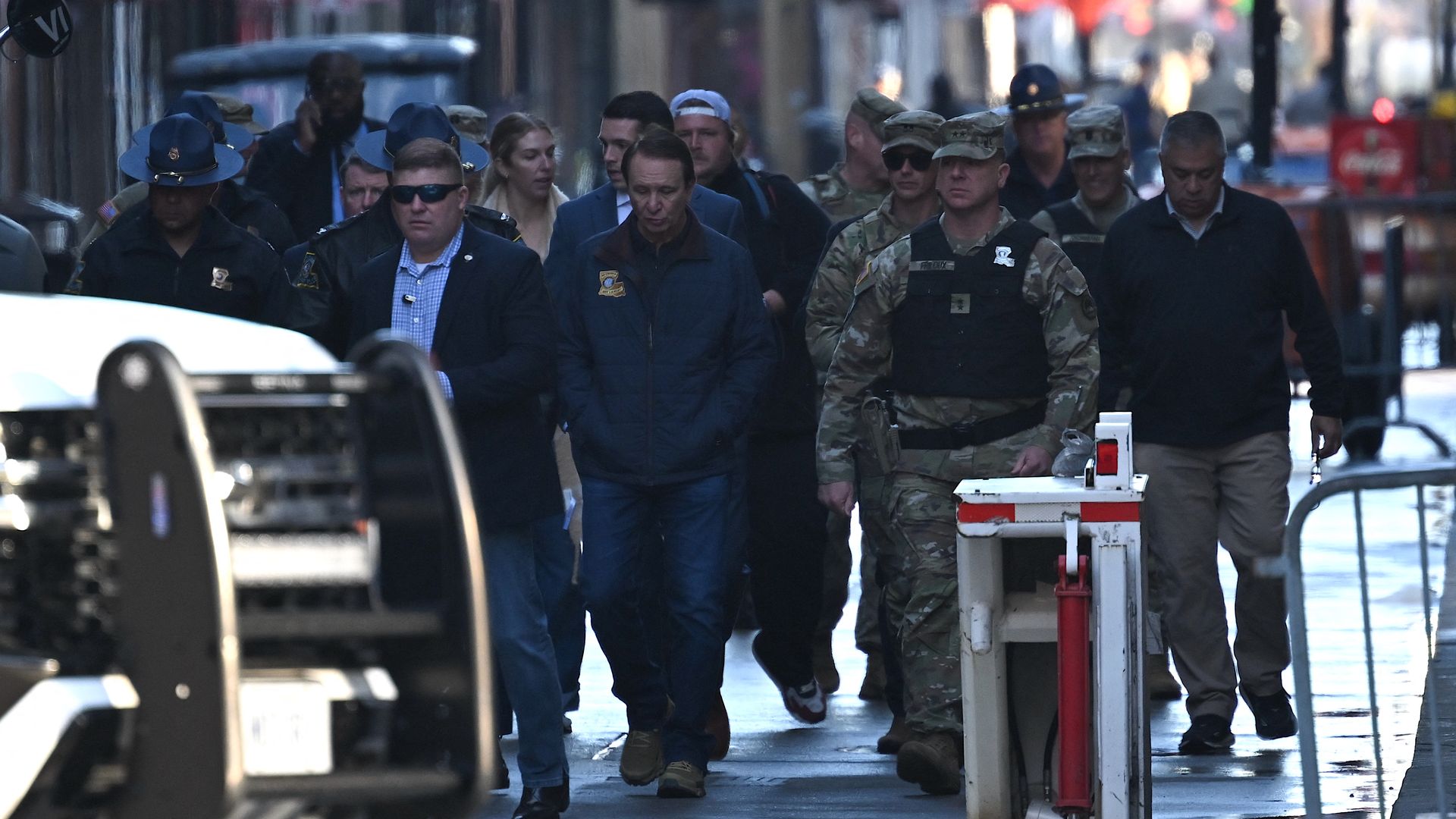 Gov. Jeff Landry, flanked by law enforcement, walks down Bourbon Street.