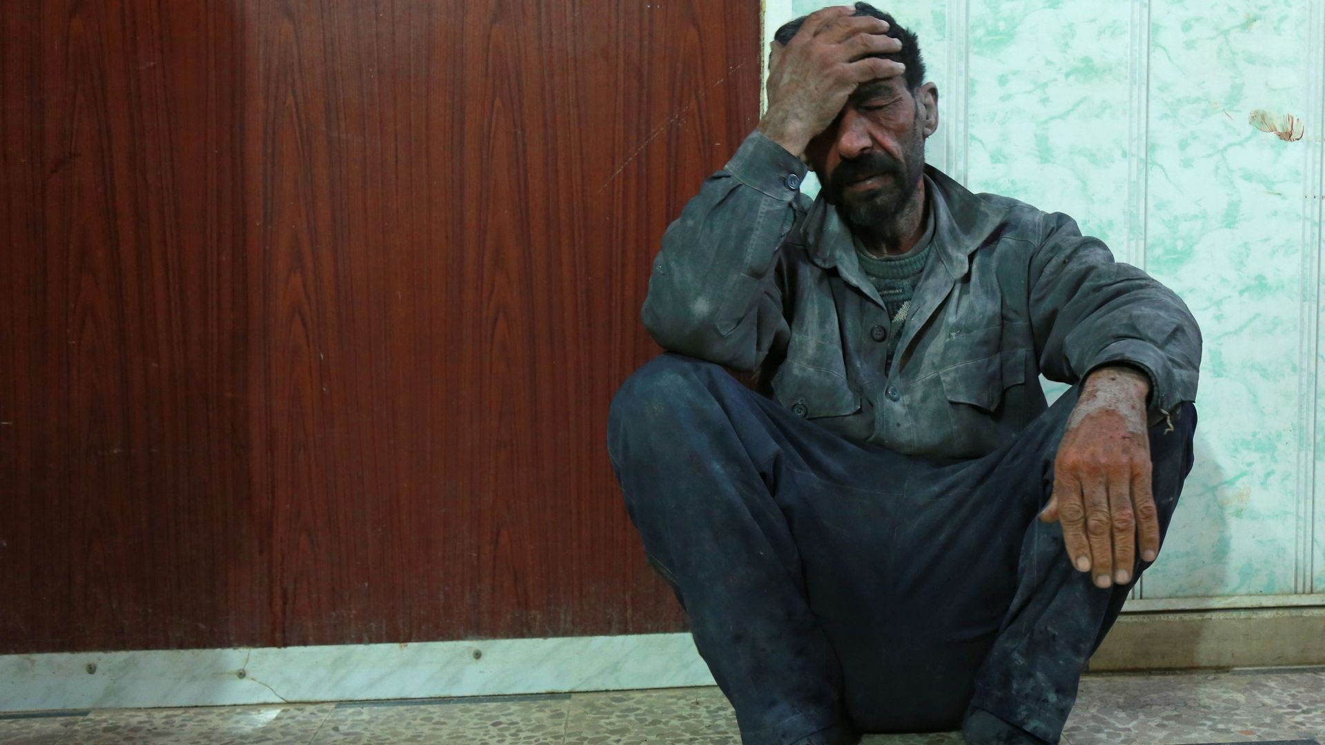 A Syrian man awaits to be treated at a makeshift hospital in the besieged Eastern Ghouta region.