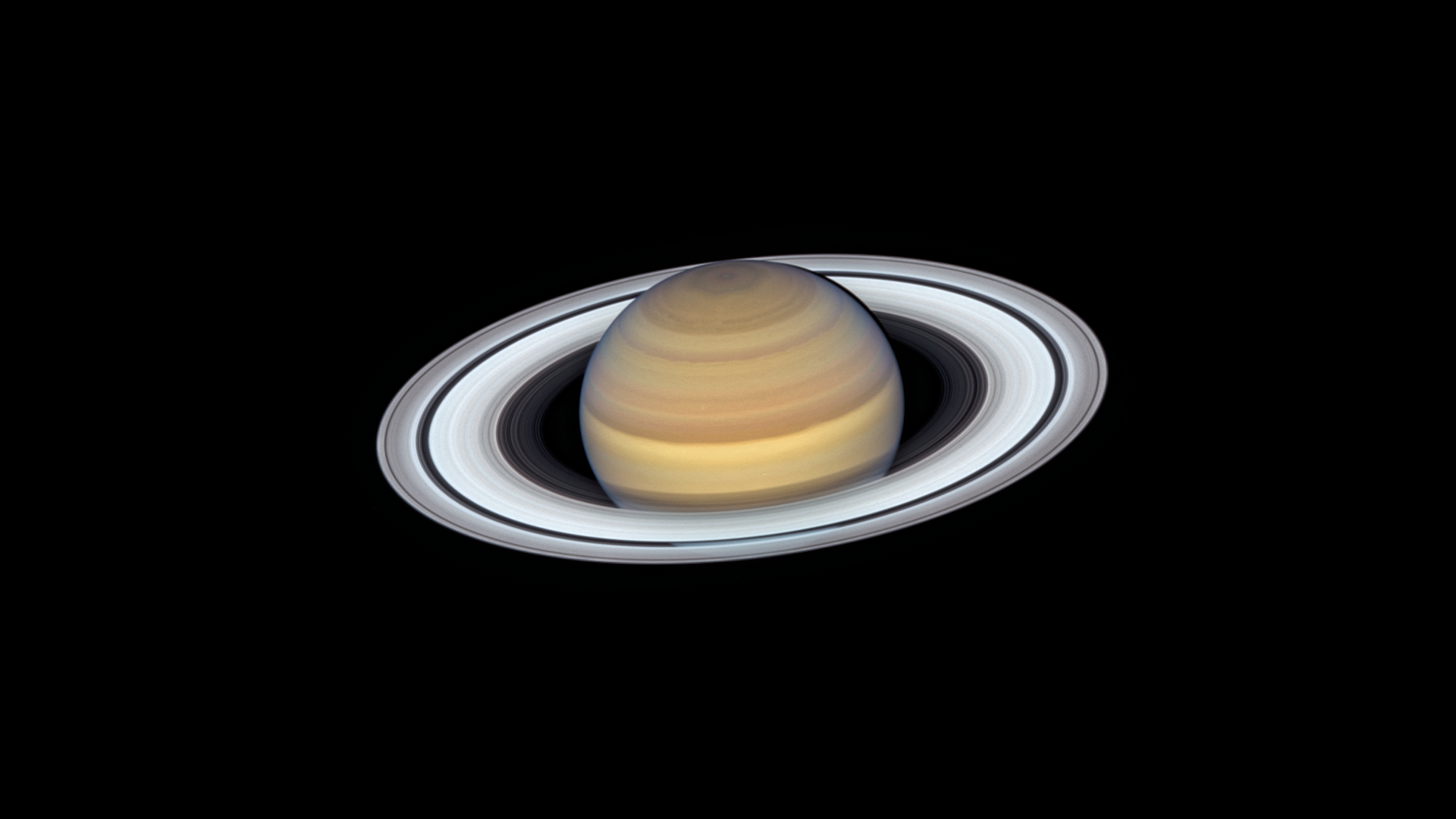 A photo of Saturn in the blackness of space.