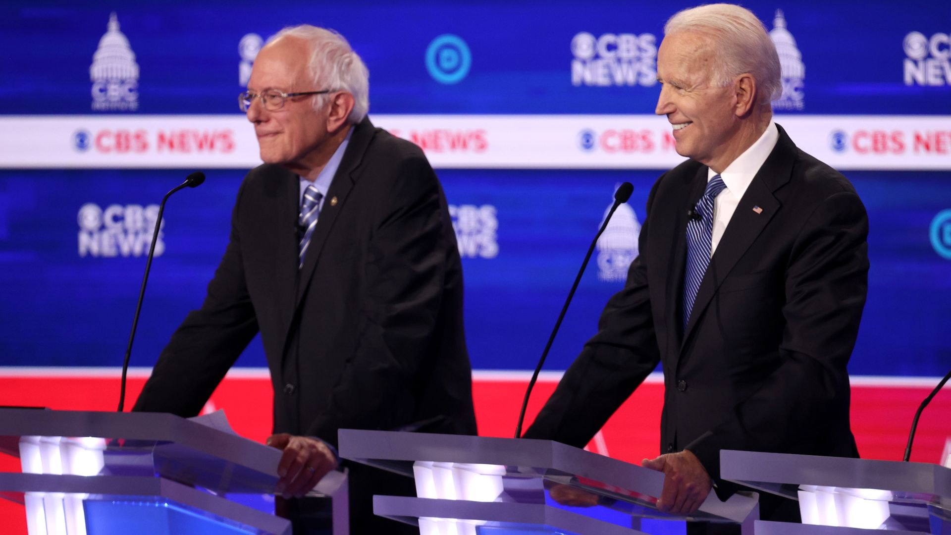 In this image, Sanders and Biden stand next to each other on the debate stage.