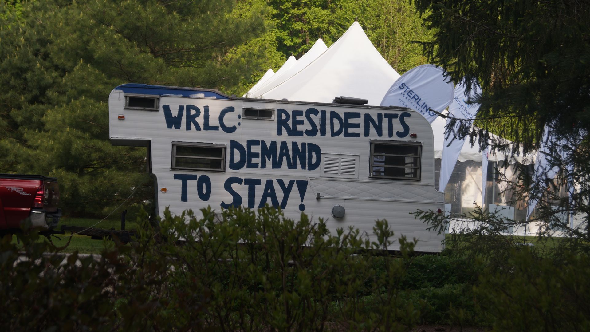 A trailer with a painted message: "WRLC: Residents demand to stay!" 