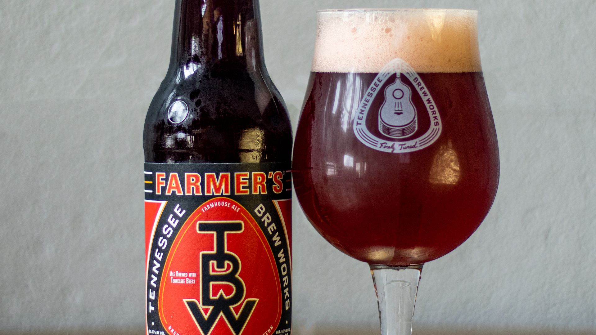 A bottle and glass of Tennessee Brew Works' Farmer's Beat beer