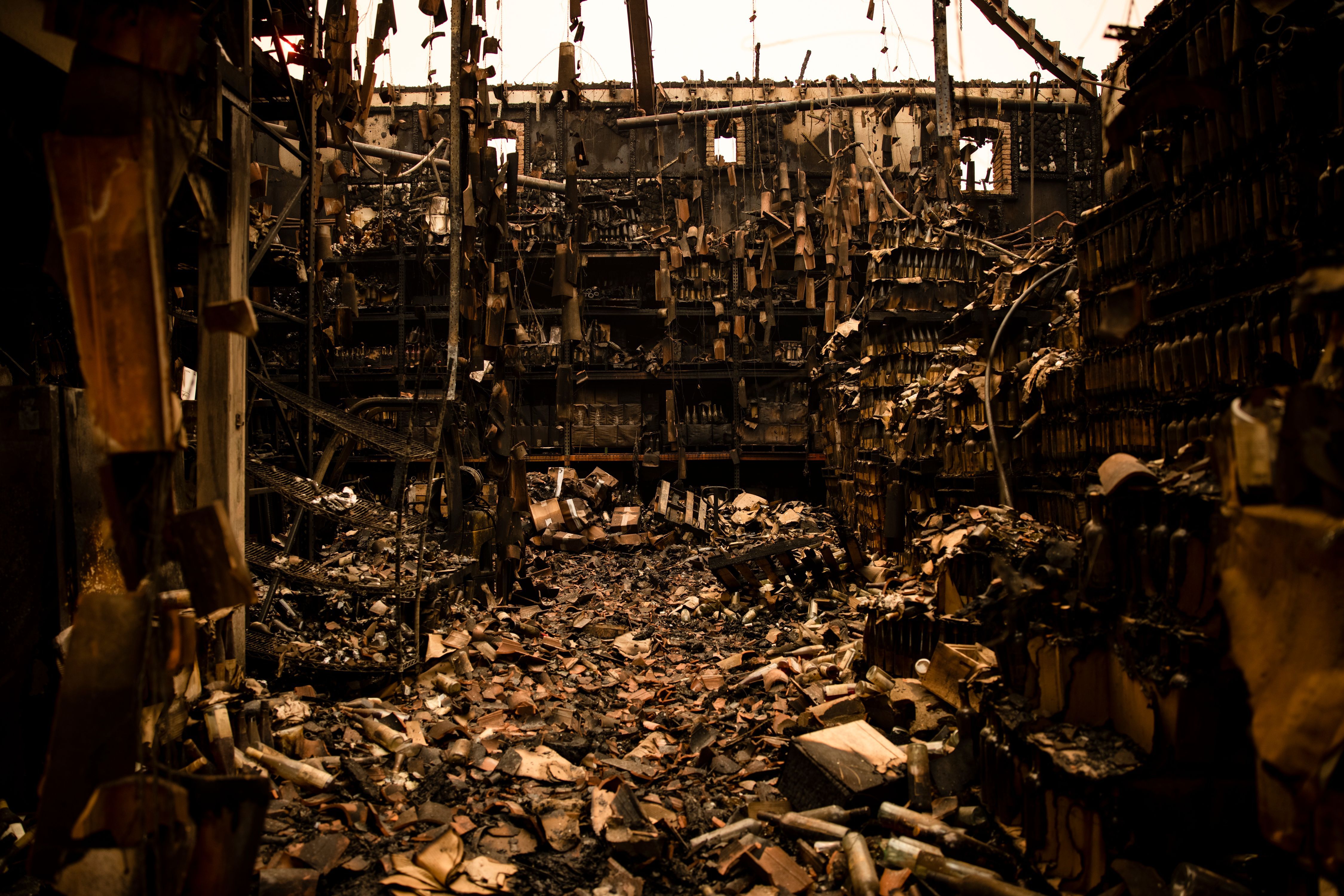  Charred bottles are seen in the remains of the a warehouse in the Farm House at the Castello di Amorosa winery which was gutted by the Glass Fire in Napa Valley, California on September 29