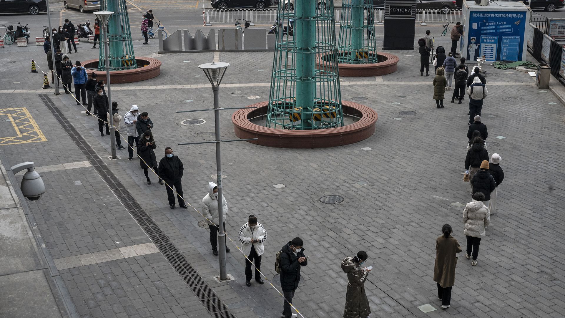 People line up for nucleic acid tests to detect COVID-19 at a public testing site on December 9, 2022 in Beijing, China.