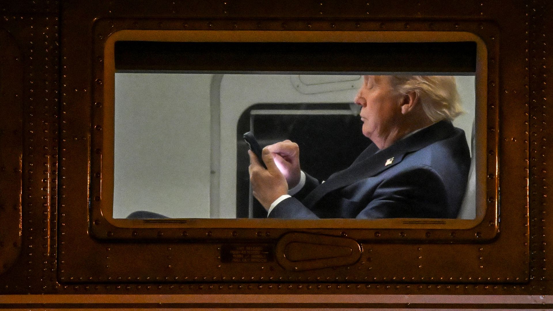 Trump uses a cellphone on Marine One