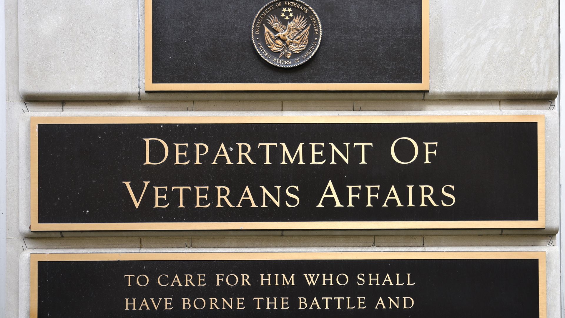 A plaque outside the VA that reads, "To care for whim who shall have borne the battle..."