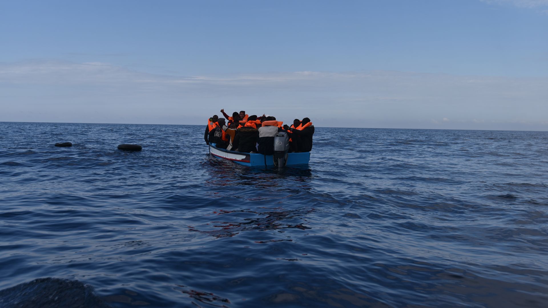 Migrants in a wooden boat, which left the coast of Libya, are waiting to be rescued by members of the NGO Open Arms, March 5, 2022, off the coast of Libya, in the Mediterranean Sea.