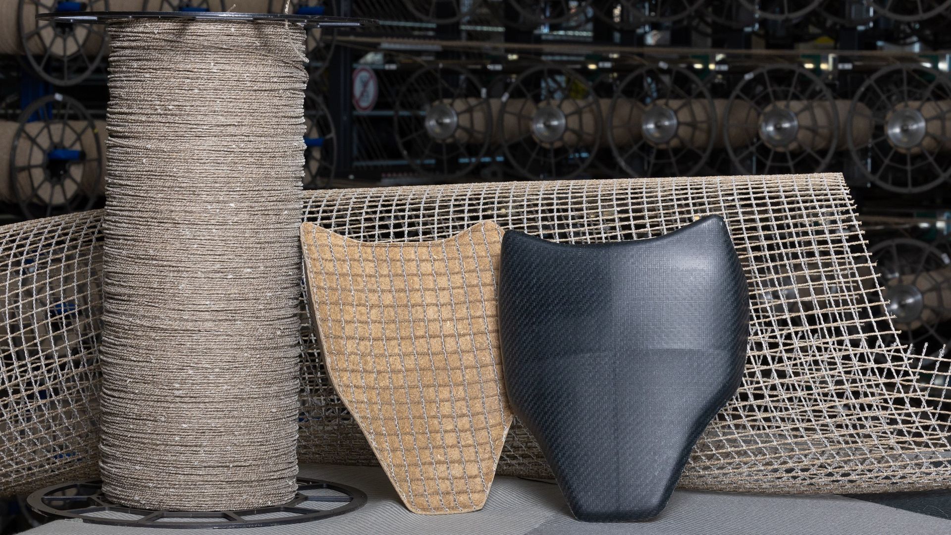 A phot of Bcomp’s brown-hued textiles, woven to illustrate how they may be used in car interiors, such as door or dashboard panels.