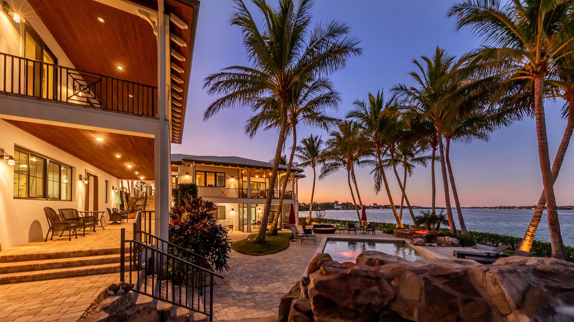the backyard of the main house with the pool and bay visible