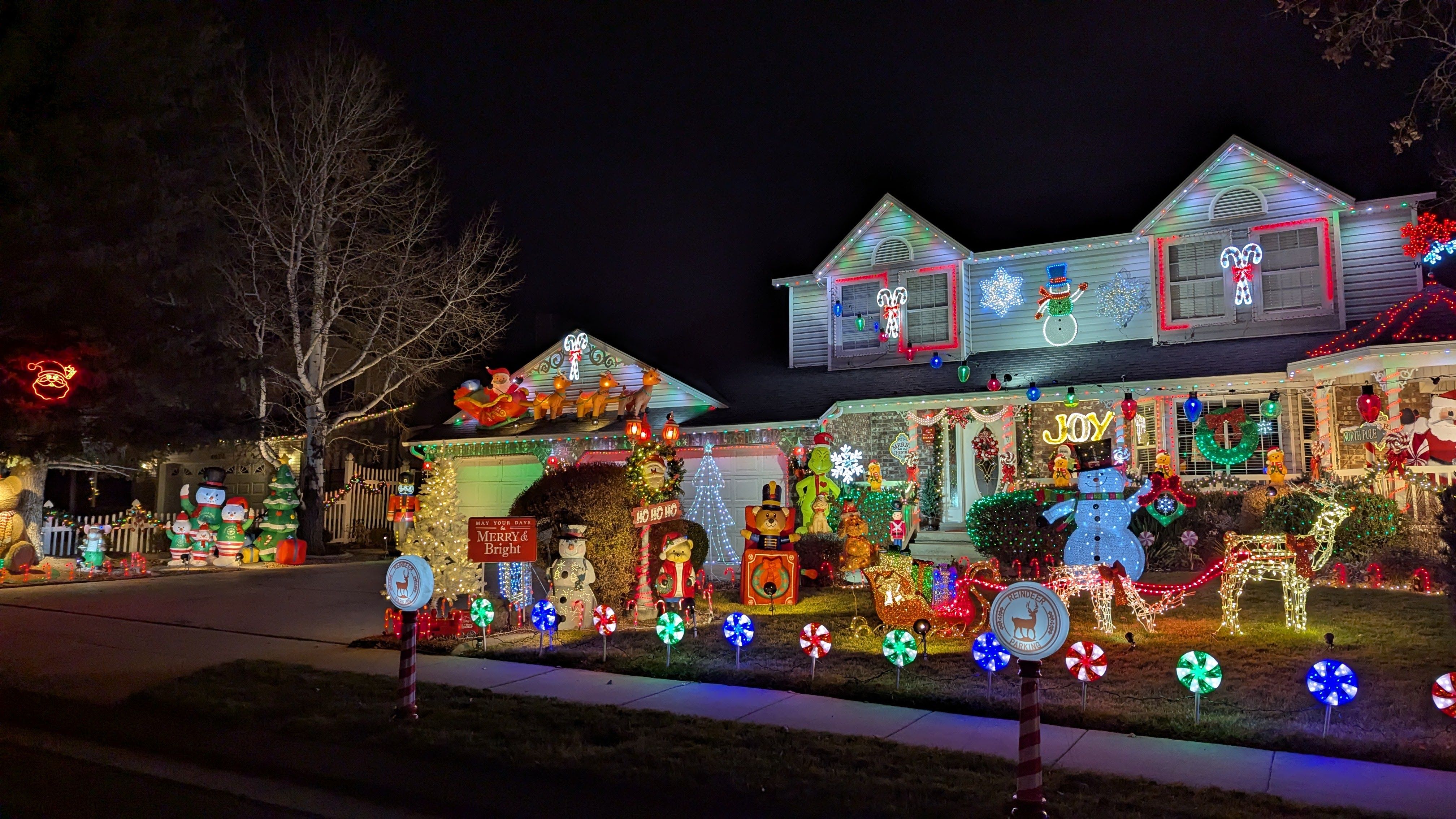 Christmas decorations lighted in front of a house. 