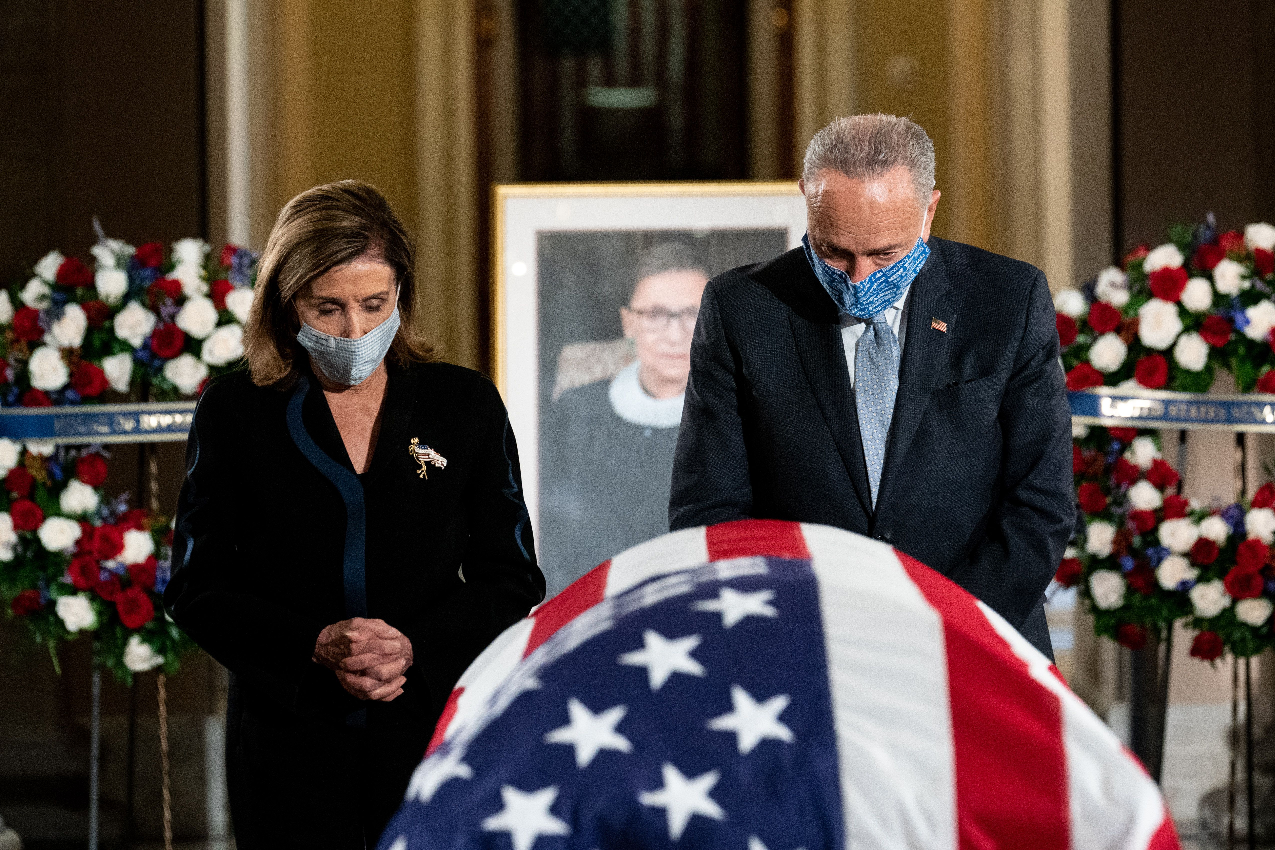 House Speaker Nancy Pelosi (D-Calif.) and Senate Minority Leader Chuck Schumer (D-N.Y.) pay their respects. Photo: Erin Schaff-Pool/Getty Images