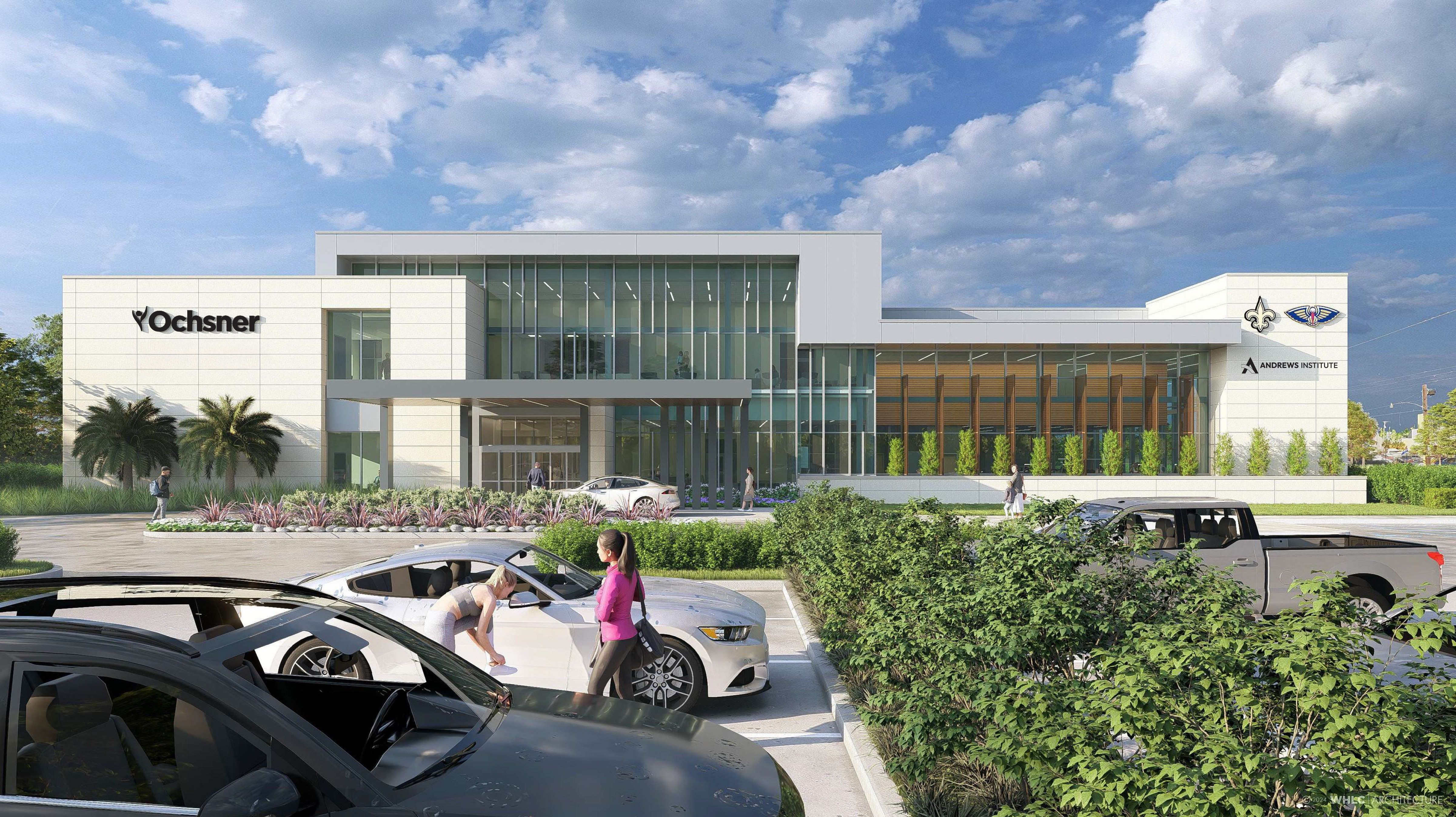 Modern Ochsner medical building with large glass windows, palm trees, landscaped greenery, and people near parked cars under a partly cloudy blue sky.