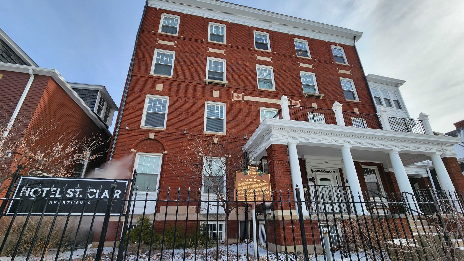 A 4-story brick building housing the St. Clair apartments.