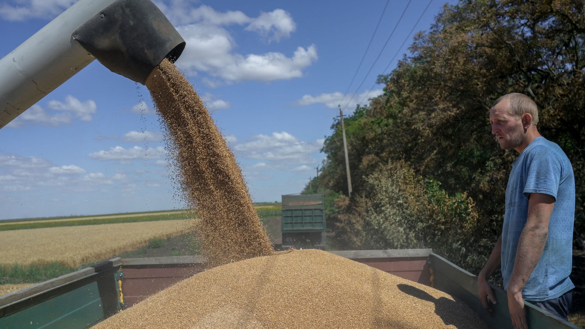 A farmer stands as he collects wheat near Mykolaiv, Ukraine, on July 21.