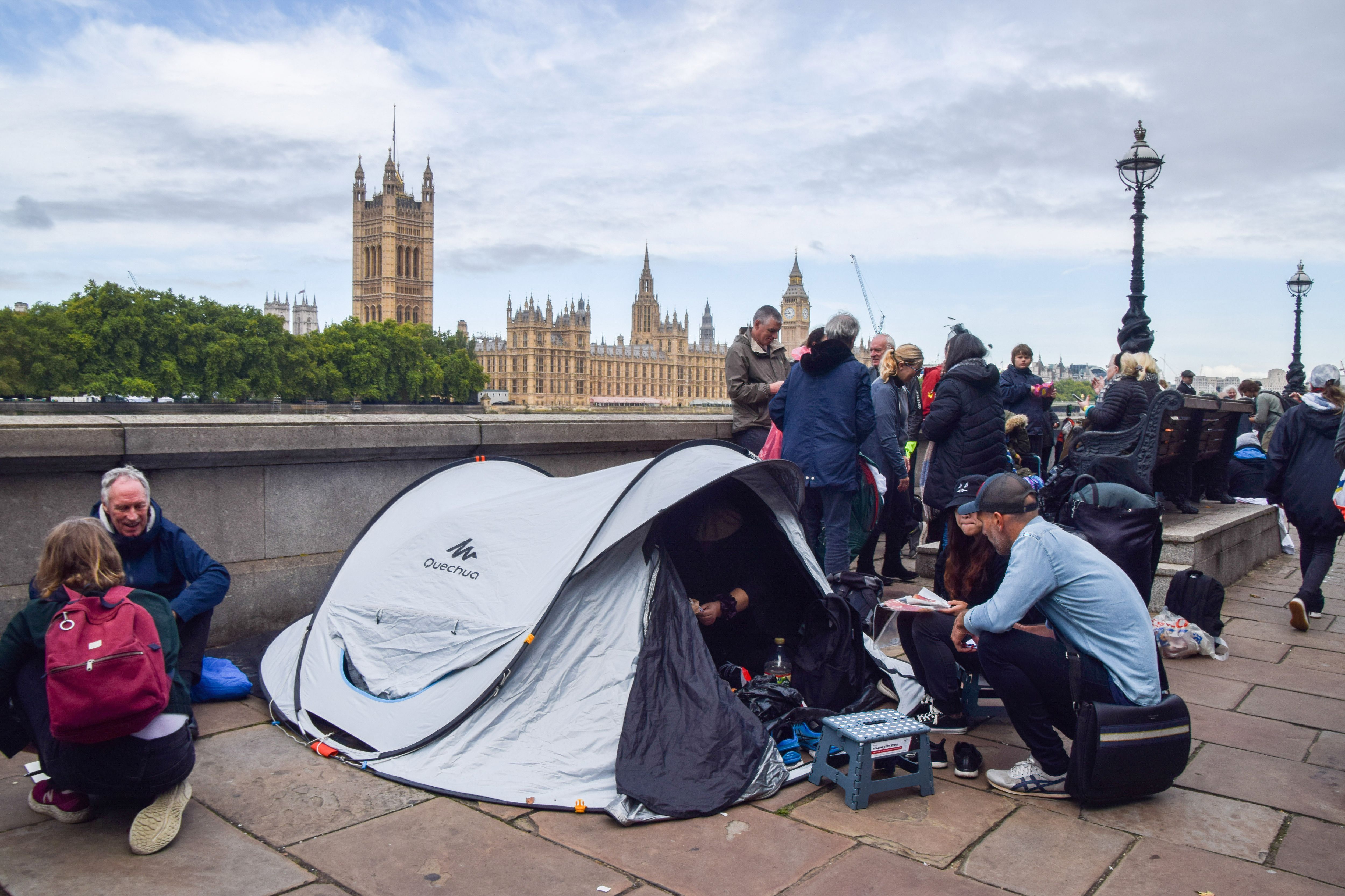  People sit inside their tent as they join the queue to pay their respects to Queen Elizabeth II who passed away on September 8th, 2022.