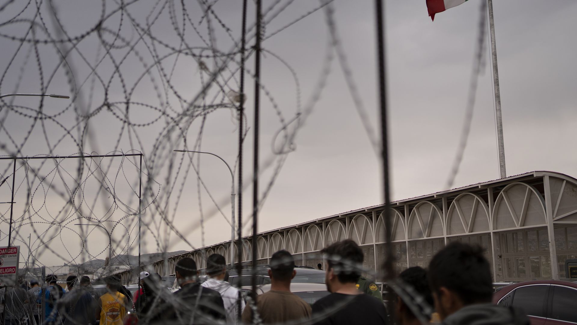 Photo of people walking near barbed wire