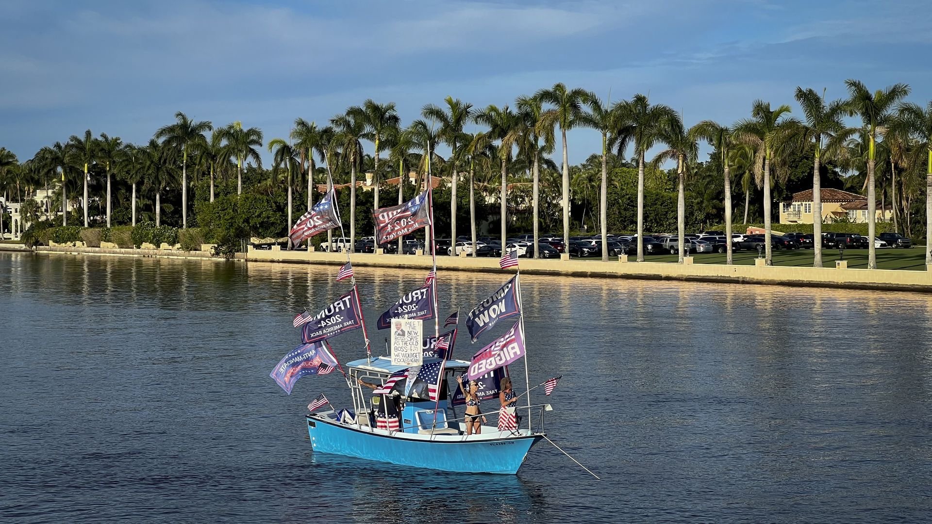 A boat bearing flags in support of Donald Trump floats near Palm Beach