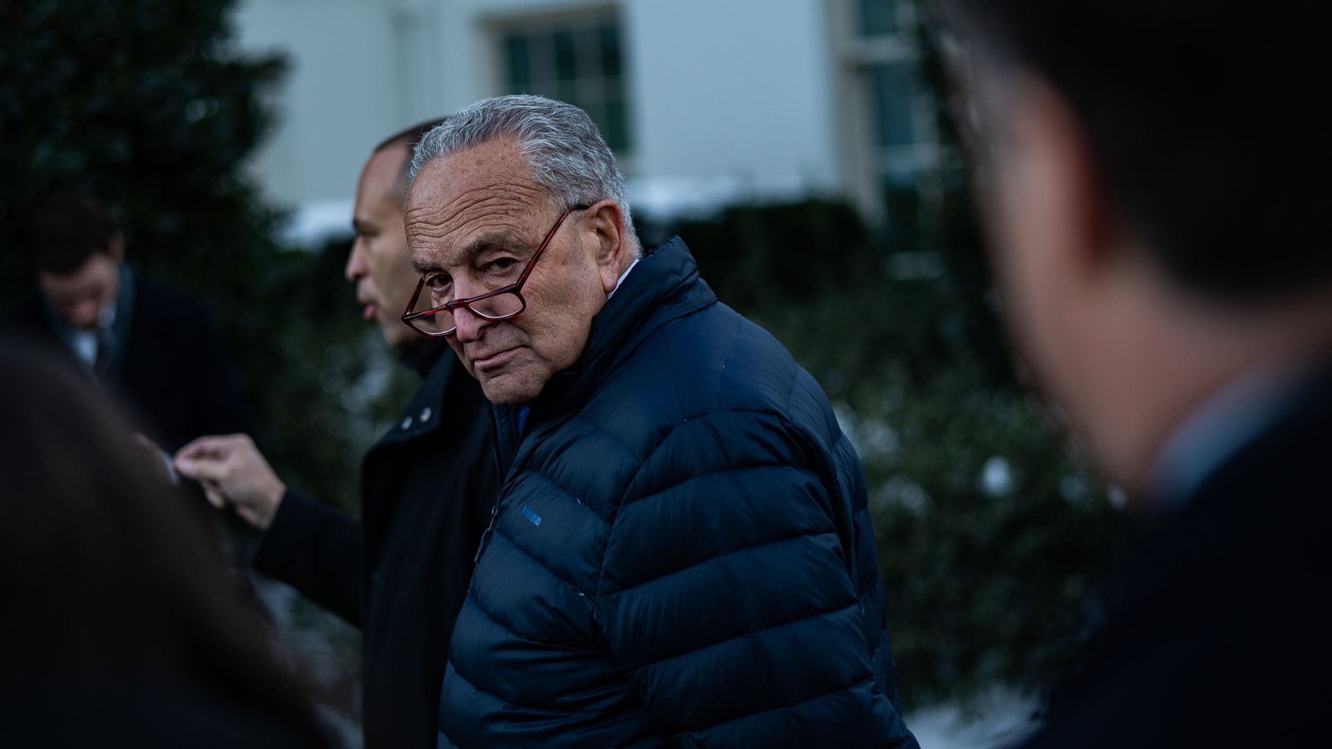 Senate Majority Leader Chuck Schumer, wearing glasses and a puffy jacket.