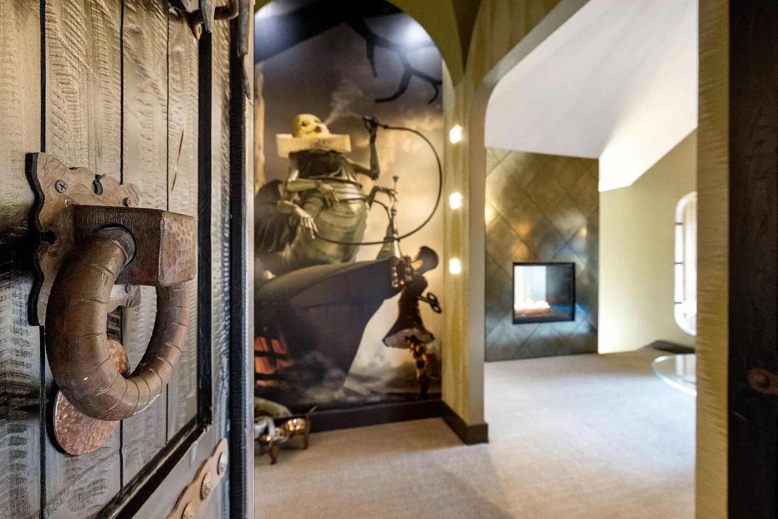 A room with a mural depicting an Alice in Wonderland scene.