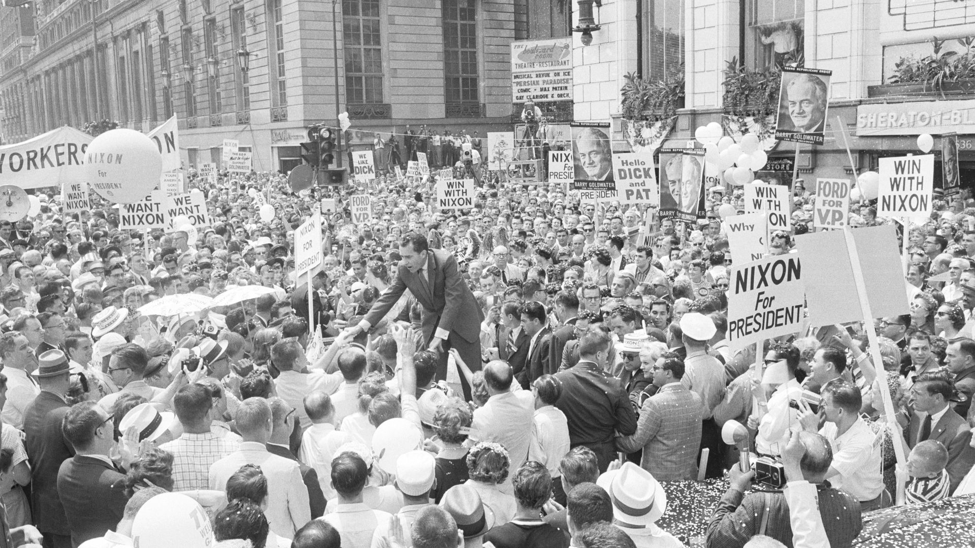 Photo of a politican greeting fans.