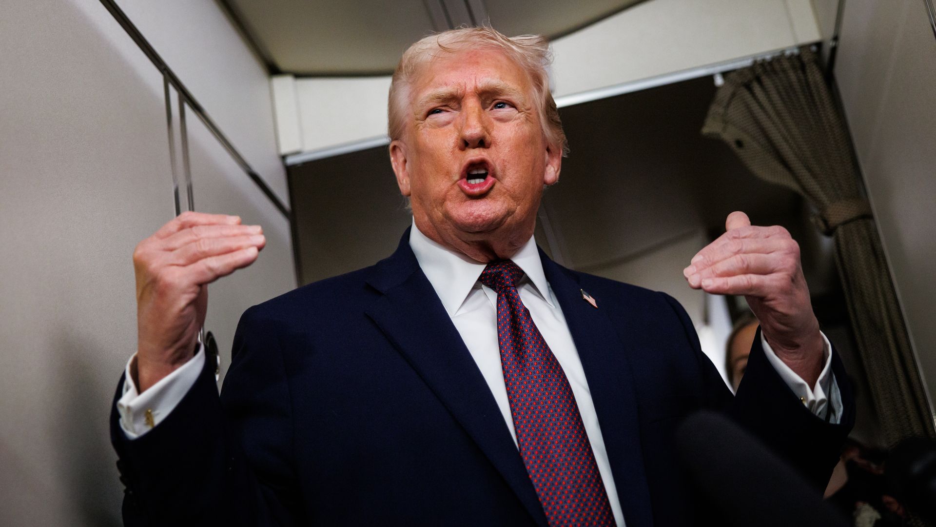 President Donald Trump talks to members of the press aboard Air Force One during a flight from Palm Beach, Florida, to Washington on Jan. 11, 2026.
