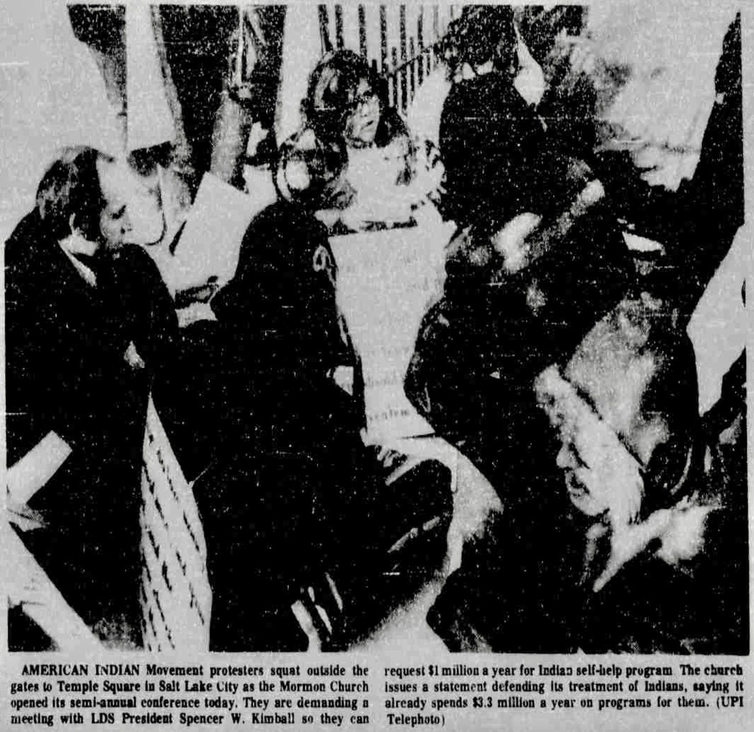 A newspaper photo from 1974 of Indigenous American protesters sitting outside the closed gates of Temple Square in Salt Lake City.