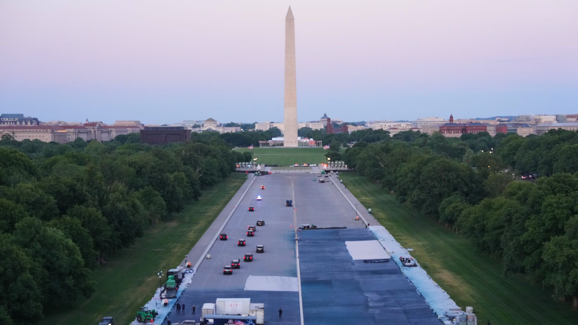 The Reflecting Pool grounds are being painted blue, seen here with vehicles on the drained pool area