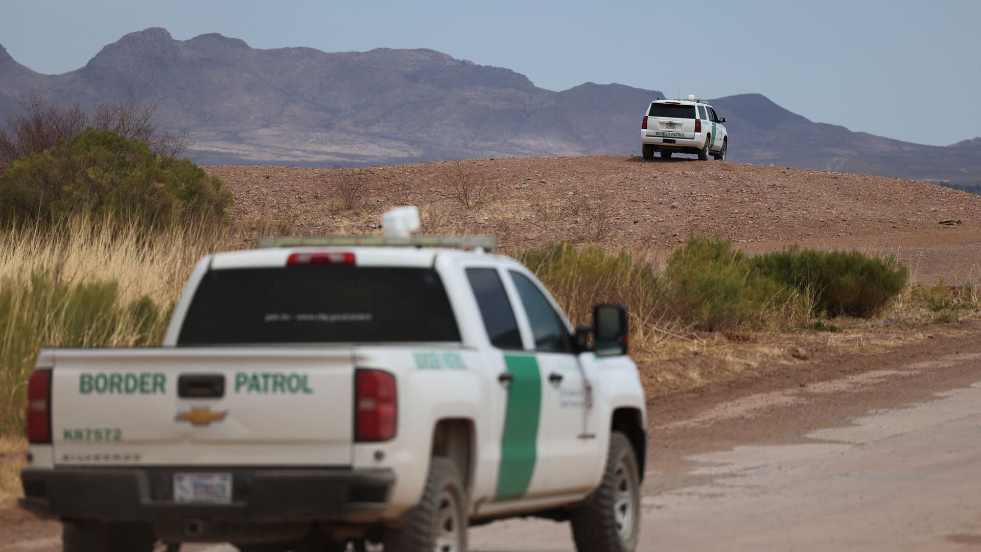 Border Patrol vehicles are seen along the fence at the southern US border with Mexico, in Douglas, Arizona.