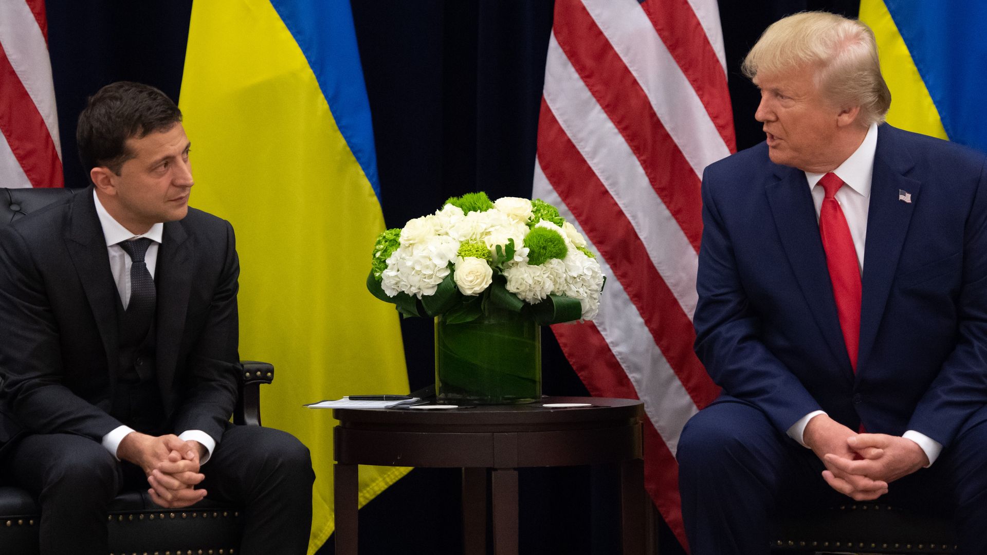 In this image, Zelensky and Trump sit across from each other.