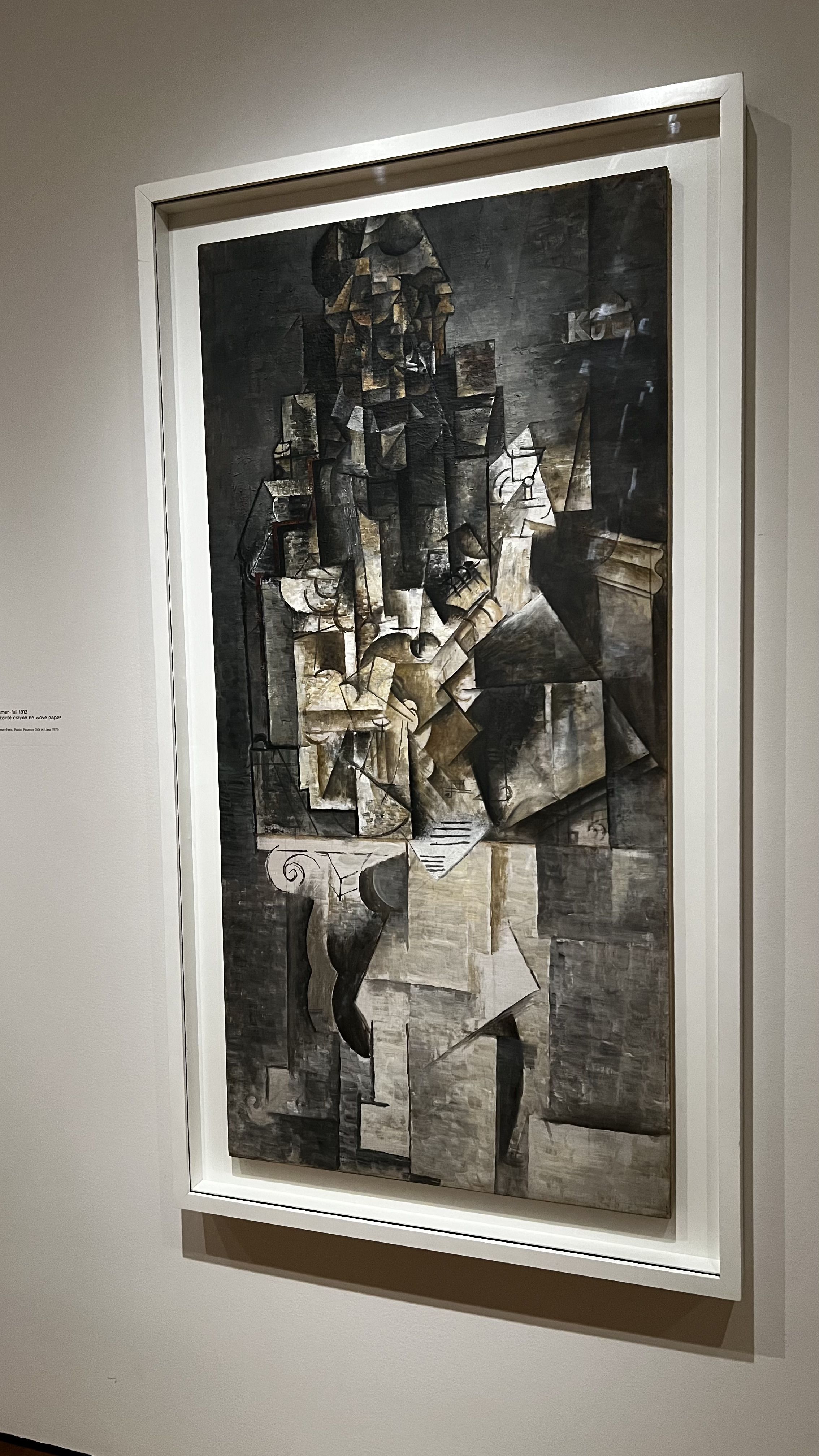 Picasso's "Man with a Guitar Painting" on a wall. 