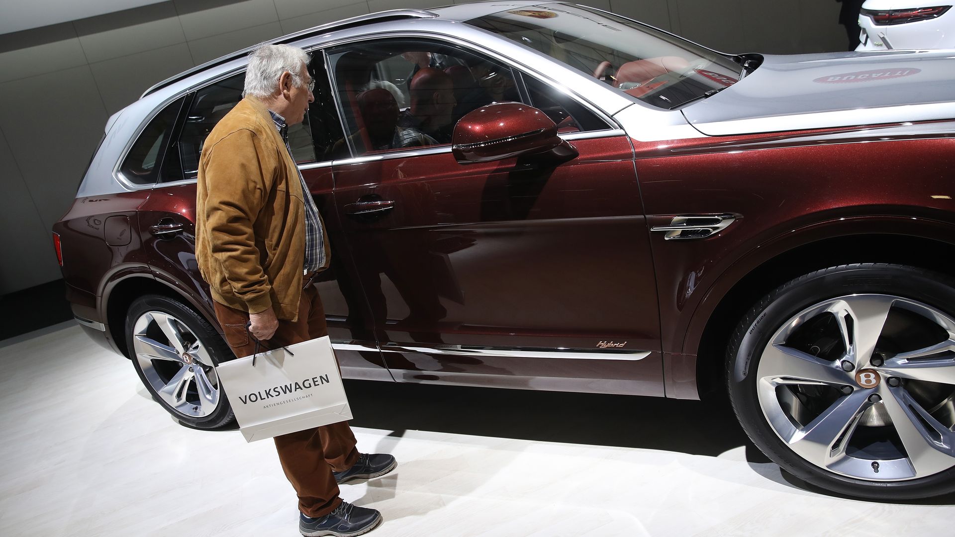 Man looking into the window of an SUV