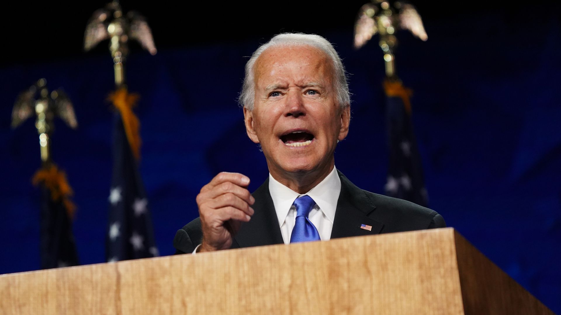 Joe Biden speaks from behind a podium 